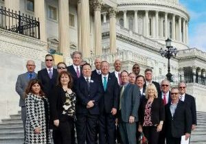 Board Members stand on steps of White House during Call on Washington event.