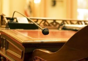 A microphone on the antique desk of a California State Senator. In the chambers of the California Senate in Sacramento.